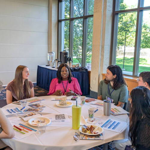 Attendees at the Social Work Convening participate in a small-group discussion.